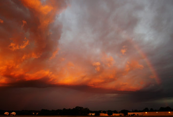 Naklejka premium Super Sunset over an Airfield with a Rainbow in front of a Storm. The State of Michigan, Grand Haven
