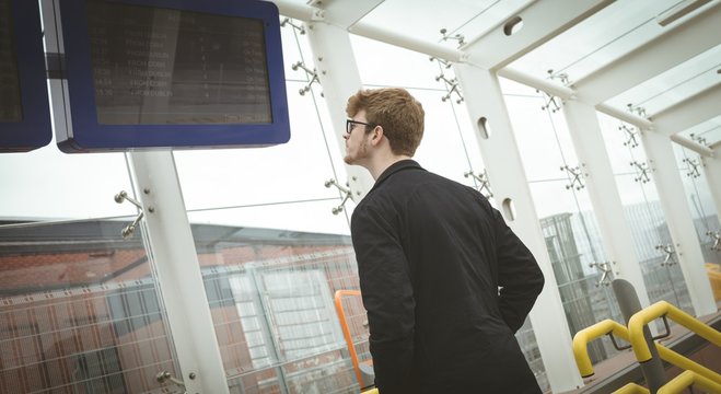 Man looking at the arrival departure board
