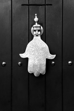 Fatima hand knocker on wooden door