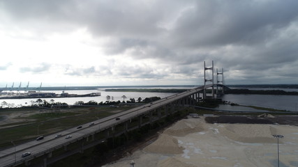 Aerial view of cars commuting on bridge in Florida on overcast day.