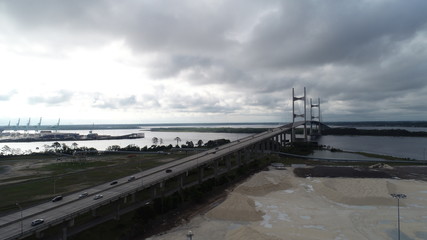 Fototapeta premium Aerial view of cars commuting on bridge in Florida on overcast day.