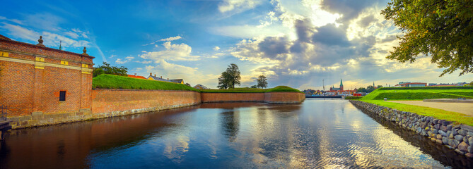 Fortress walls and moat with water in Kronborg castle at sunset. Helsingor, Denmark