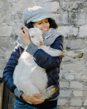 Woman hugging goat