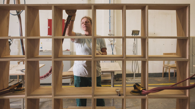 Female Worker In The Uniform Working At The Furniture Factory
