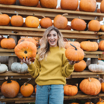 A young woman at a pumpkin patch