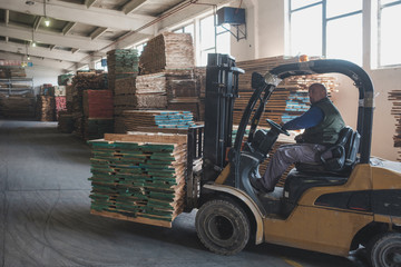 Man Driving Forklift in The Furniture Factory Warehouse
