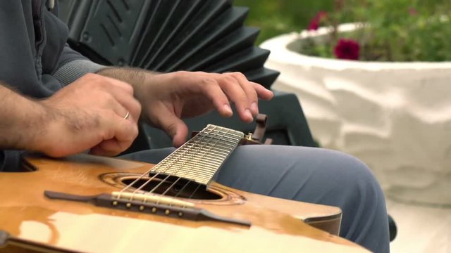 Close-up of playing guitar.