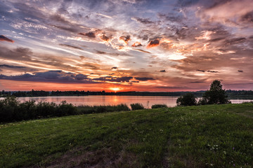 Naklejka na ściany i meble Sunset over the lake in summer