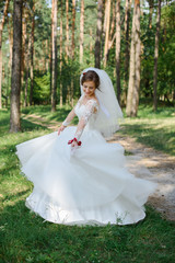Fototapeta na wymiar Beautiful bride in wedding dress. Happy newlywed woman. Bride with wedding makeup and hairstyle. Smiling bride. Wedding day. Gorgeous bride. Marriage.