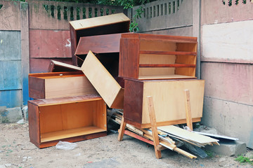 old wooden furniture thrown into the trash