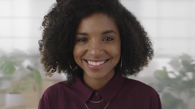 portrait of beautiful young african american business woman smiling cheerful looking at camera enjoying successful lifestyle