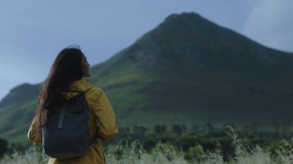 young indian woman hiking enjoying calm scenic mountain landscape wind blowing hair independent female tourist on adventure travel journey