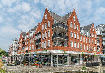 Fototapeta premium Groesbeek, The Netherlands 19th July 2018 - People enjoying a drink and food outside a modern Building with restaurant and shops