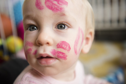 baby boy with kiss marks all over face
