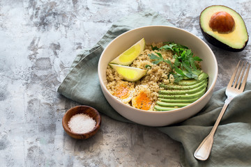 Healthy bowl with quinoa, eggs, avocado, lime and parsley. Food and health.