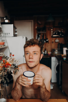 blond boy drinking coffee in the morning