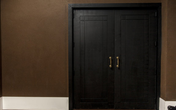 golden knob on a black wooden door