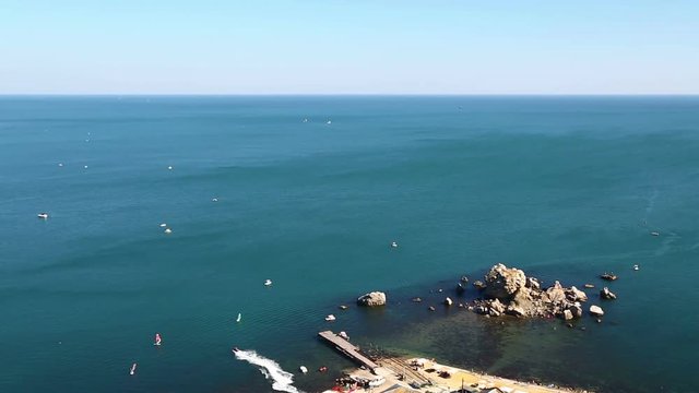 Motor boats float in a sea bay with a sea current. View from above. Time laps