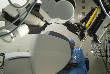 Doctor Operating With a Robotic Surgical Instrument. Surgeons use a magnified 3D high-definition...