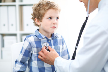 Doctor and child patient. Physician examines little boy by stethoscope. Medicine and children's...