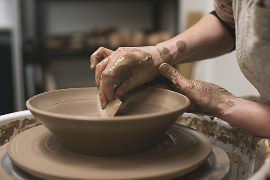 A ceramic Artist works in her potter studio