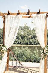 wedding arch on the river bank