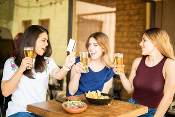 Woman buying drinks with credit card