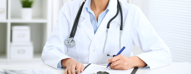 Doctor woman working at hospital.  Closeup of stethoscope. Health care, insurance and help concept