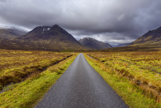 Road with mountains in the highlands at Glen Coe in Scotland, United Kingdom