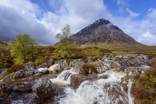 Waterfall on River Coupal and mountain range Buachaille Etive Mor at Glen Coe in Scotland, United Kingdom