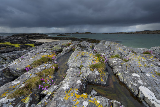 Scottish coast in spring with rain clouds over the ocean at Mallaig in Scotland, United Kingdom