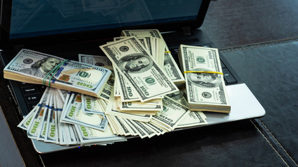 Macro shot of 100 dollar. Dollars Close Up Concept. American Dollars Cash Money. Lots of money on the laptop. Business, computers