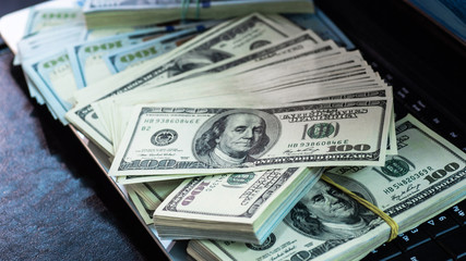 Macro shot of 100 dollar. Dollars Close Up Concept. American Dollars Cash Money. Lots of money on the laptop. Business, computers