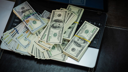 Macro shot of 100 dollar. Dollars Close Up Concept. American Dollars Cash Money. Lots of money on the laptop. Business, computers