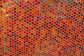red texture of a shallow round mosaic on the wall