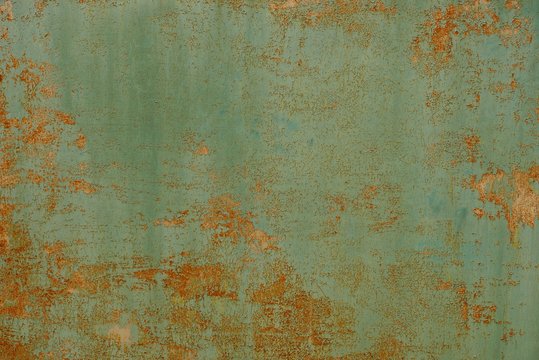 green red rusty metal texture from an old wall