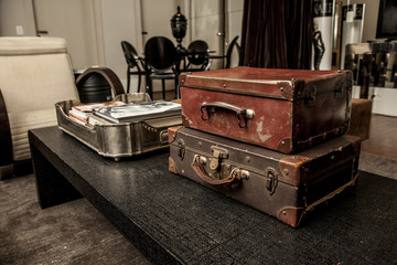 Vintage Pile Ancient Suitcases Form of Tower Design Concept Travel Luggage on a vintage living room
