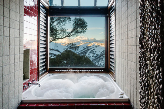 bathroom with spa bath and view to snow covered mountains