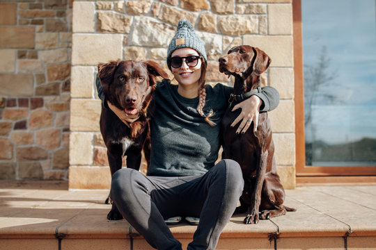 Young woman with two brown dogs