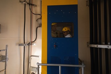 Engineer standing inside service lift