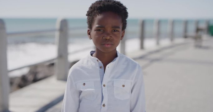 portrait unhappy african american boy looking sad little kid on sunny seaside real people series