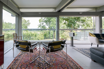 Two modern chrome chairs set in a contemporary sitting room.