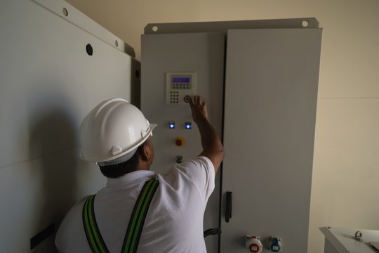 Engineer Operating A Machine Inside The Wind Mill