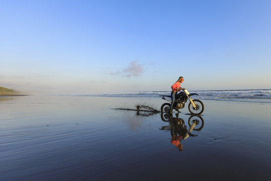 Young woman on a Motocross bike is getting stuck