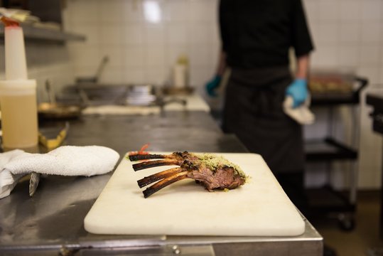 Chicken Pieces Kept On Chopping Board In Kitchen