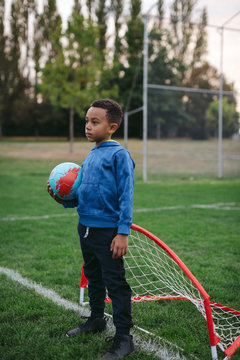 Little boy having fun learning soccer skills outside