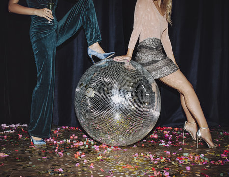 Women Posing With Disco Ball