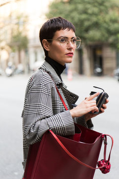 Stylish short haired business woman commuting between meetings on a busy city