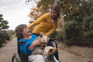 Granddaughter taking grandmother out for a walk