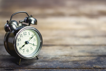 Retro alarm clock on a wooden table.